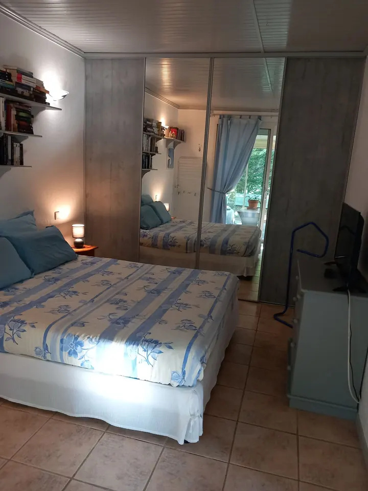 Bedroom with large mirrored wardrobe